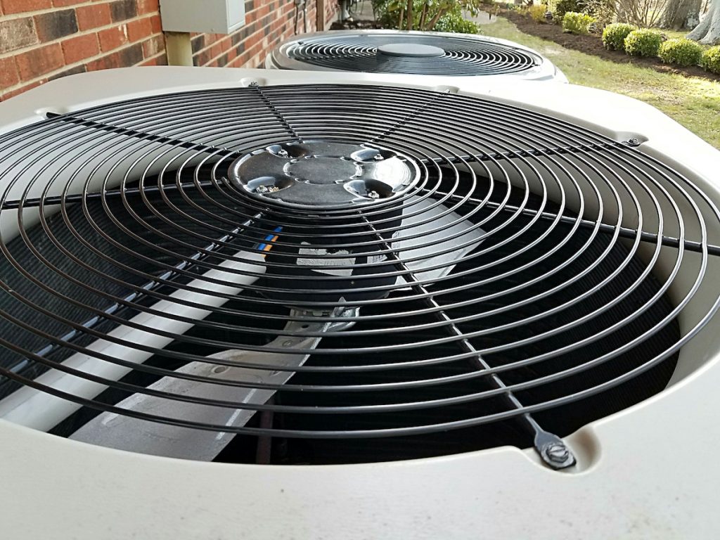 An up-close photo of an air conditioning unit's fan. 