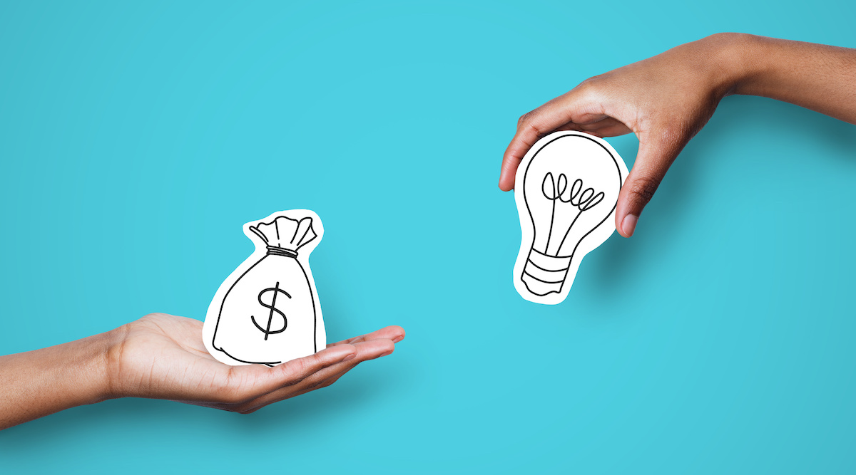 Two hands holding a drawing of a money bag and a light bulb against a blue background. HELOC alternatives.